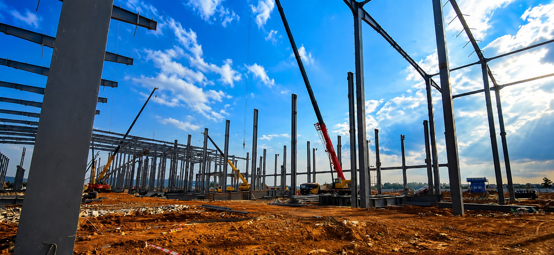 Steel structure installation site with cranes and columns